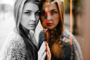 woman leaning against mirror learning more about what dual diagnosis is