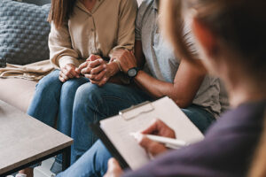 a couple talks to a therapist during family therapy