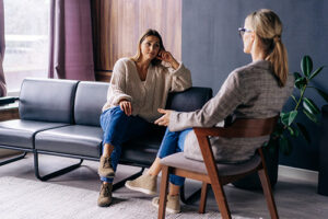 a person talks to a therapist during opioid addiction rehab