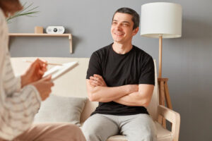 patient in clinic smiling, man enjoying consultation solving mental problems 