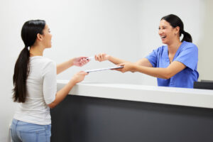 mental health professional and client pass a clipboard over desk while learning what is DBT